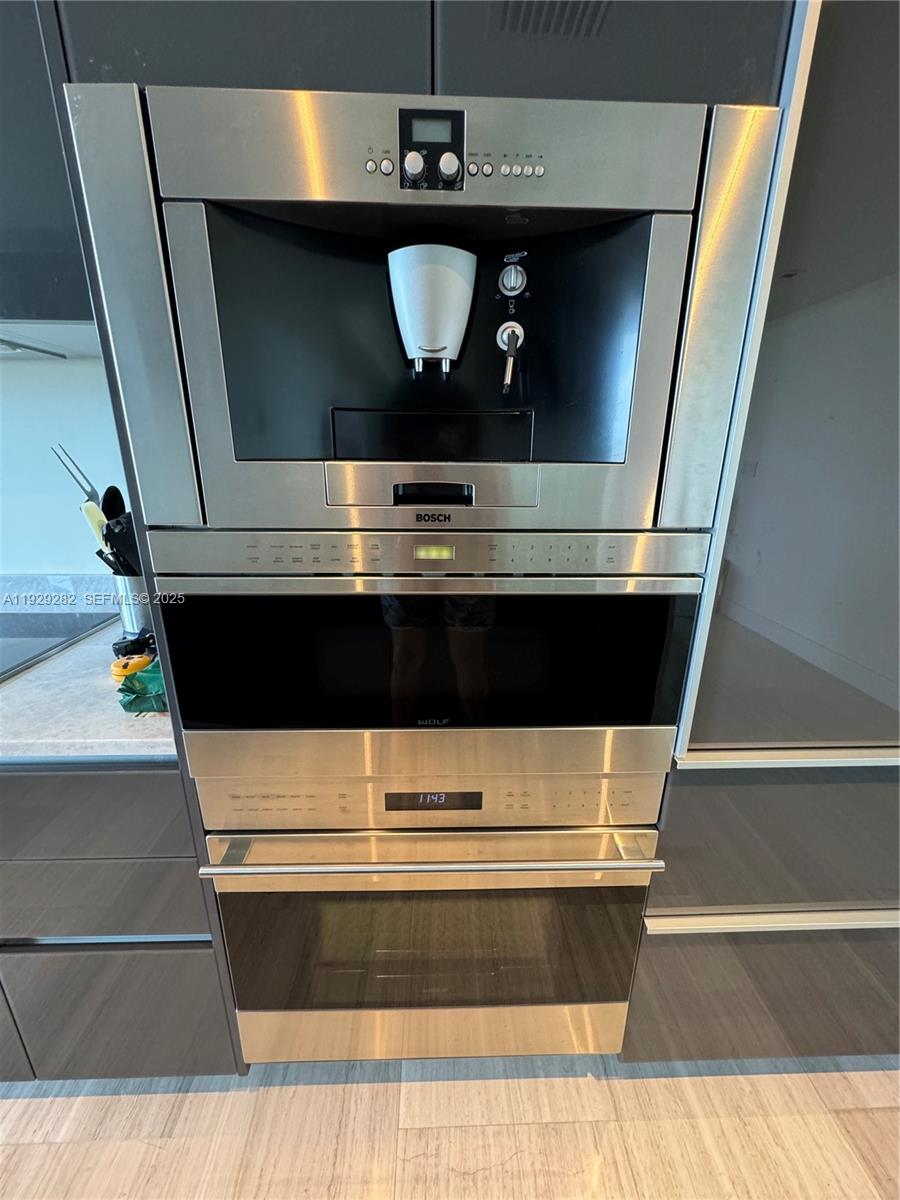 1451 Brickell Avenue, Unit 1105 Miami, FL 33131 - Photo 17 of 43 a stove top oven sitting inside of a kitchen