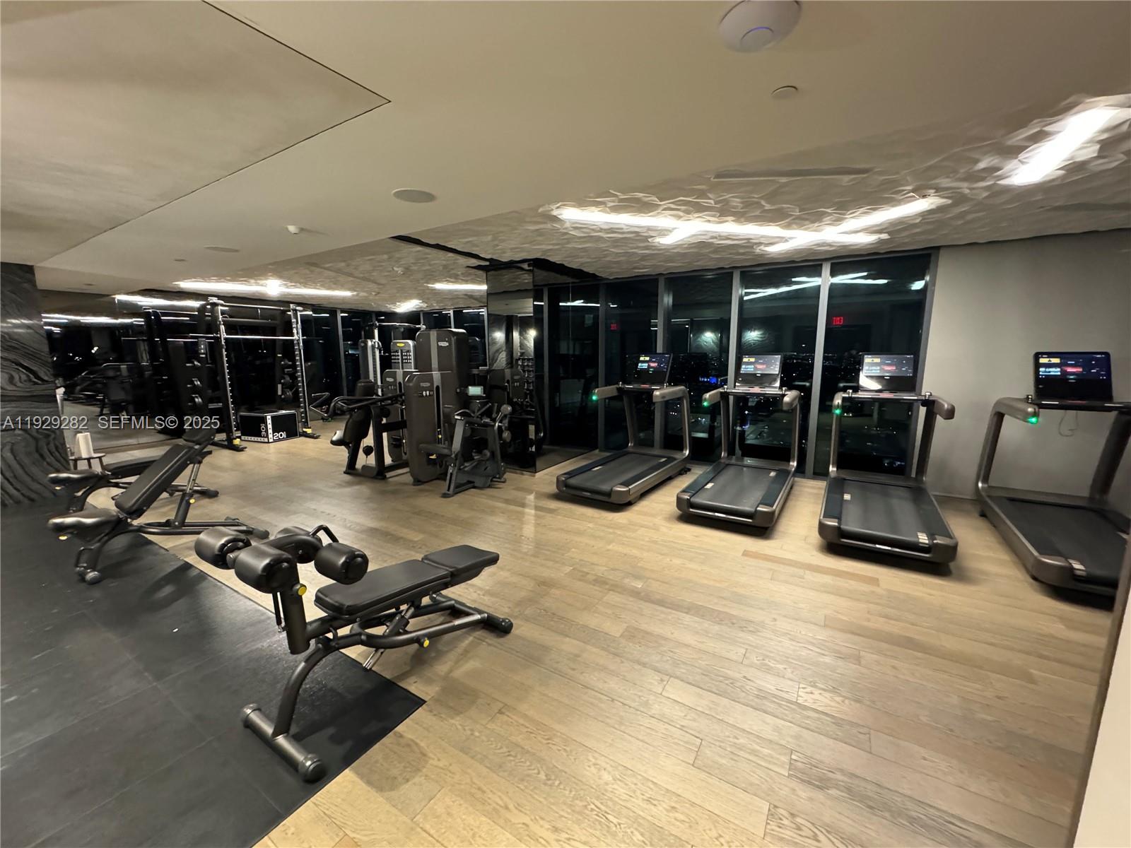 1451 Brickell Avenue, Unit 1105 Miami, FL 33131 - Photo 28 of 43 a view of a room with gym equipment