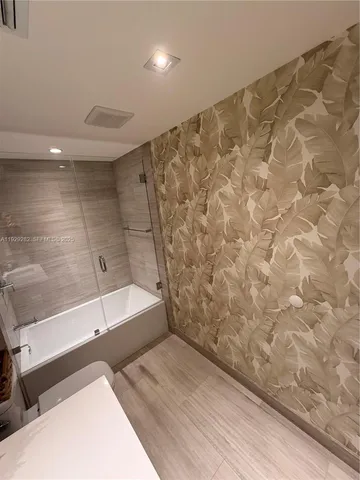 a bathroom with a bathtub and a shower