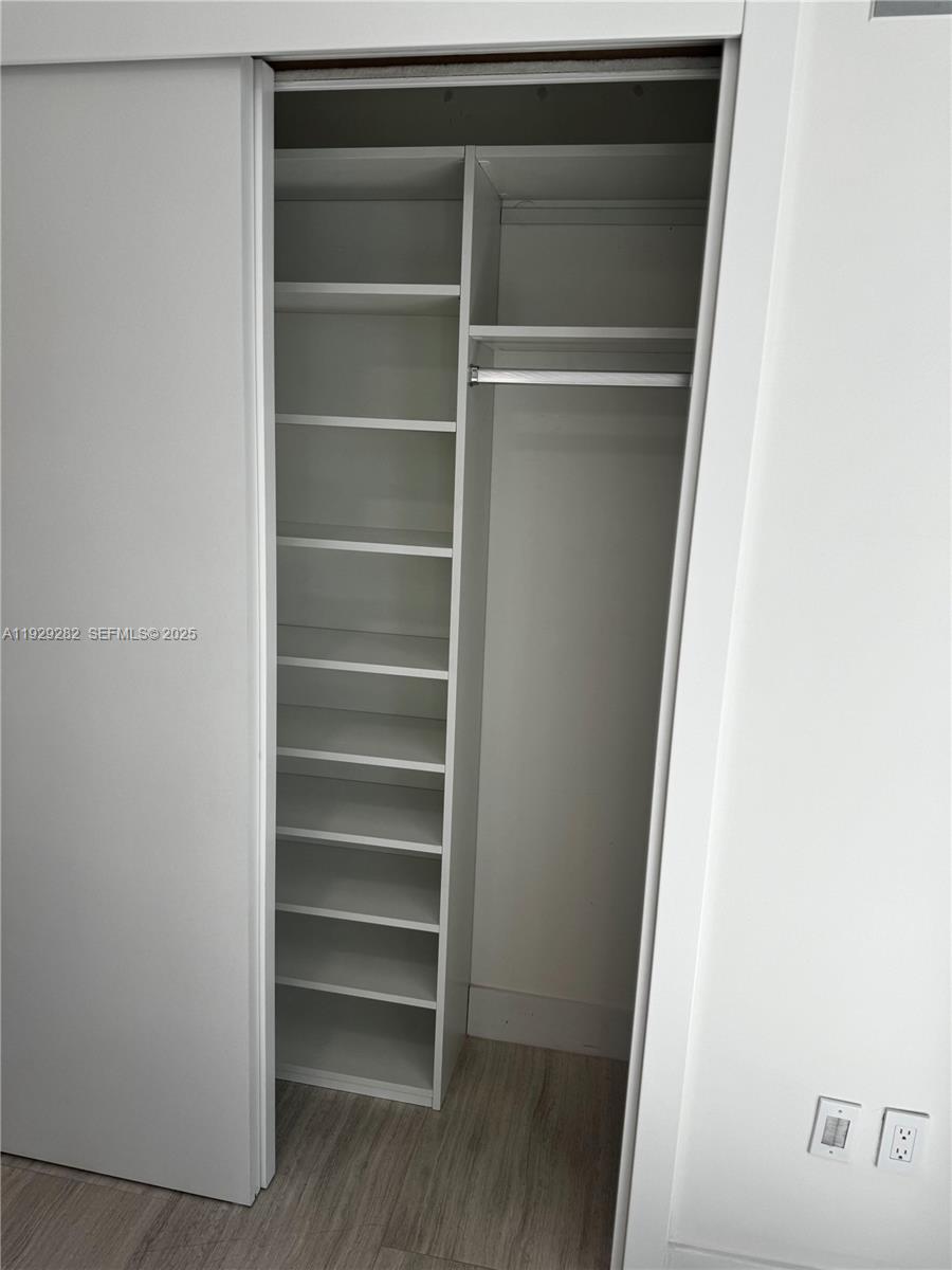 1451 Brickell Avenue, Unit 1105 Miami, FL 33131 - Photo 41 of 43 a view of walk in closet with empty racks