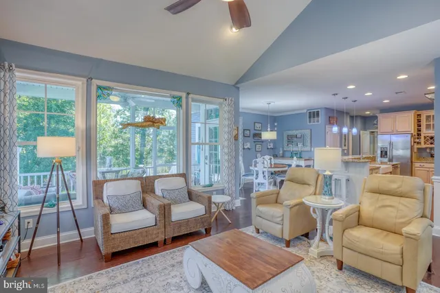 a kitchen with kitchen island granite countertop wooden cabinets and refrigerator