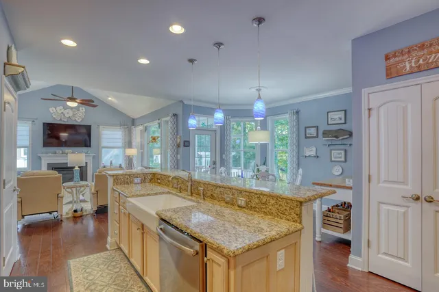 a bathroom with a granite countertop sink a toilet a bathtub and mirror