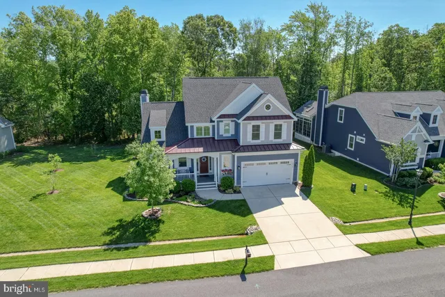 a living room with furniture a bookshelf and a window