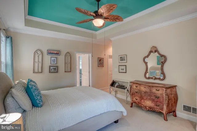 a living room with furniture a flat screen tv and kitchen view