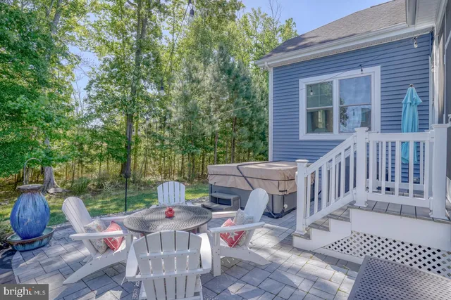 a living room with furniture a chandelier and a fireplace