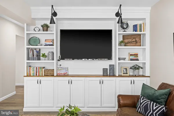 a open kitchen with stainless steel appliances granite countertop a stove and chairs with wooden floors