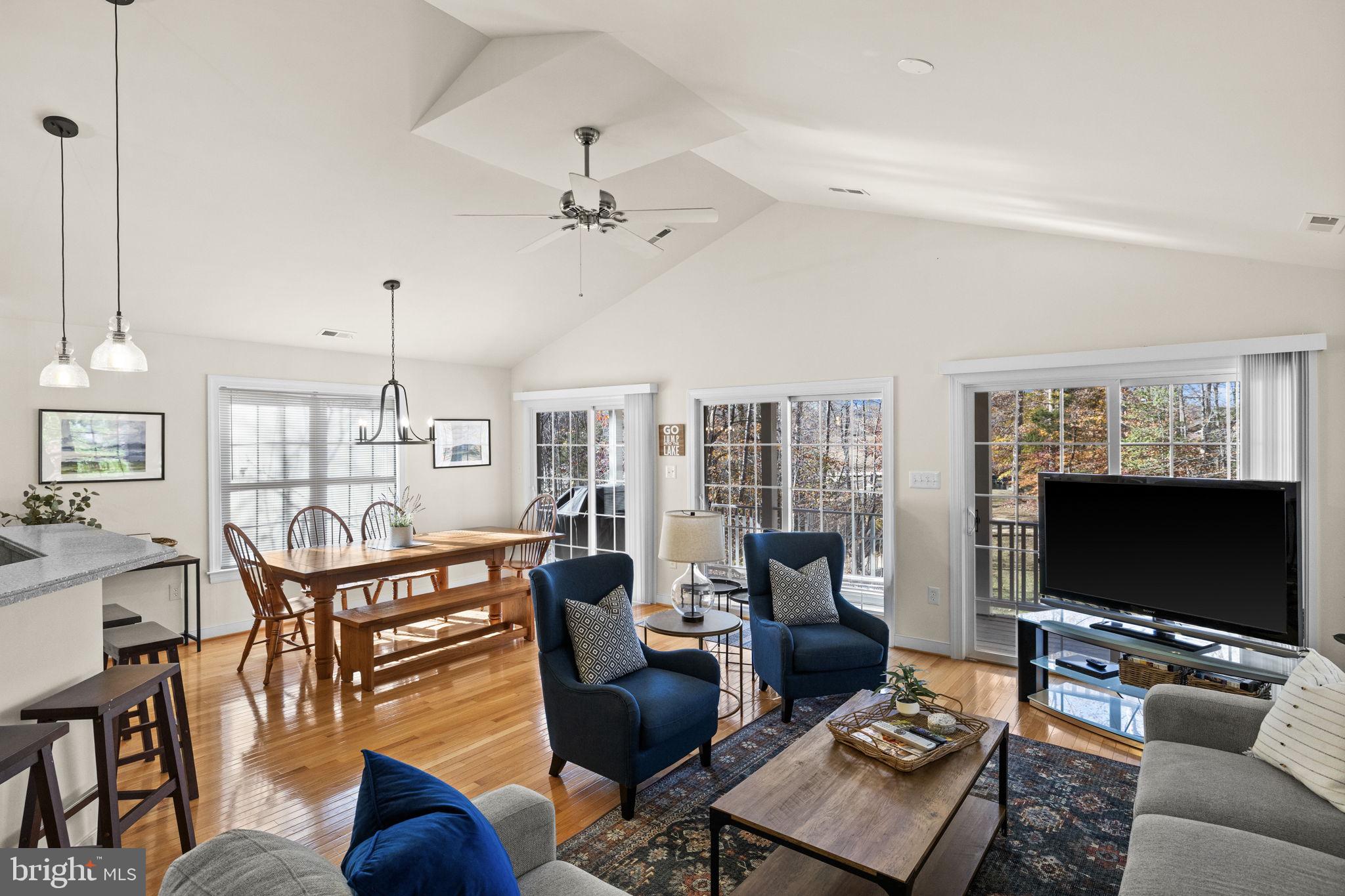 14 Oak Road Bumpass, VA 23024 - Photo 25 of 75 a living room with furniture a flat screen tv and a floor to ceiling window