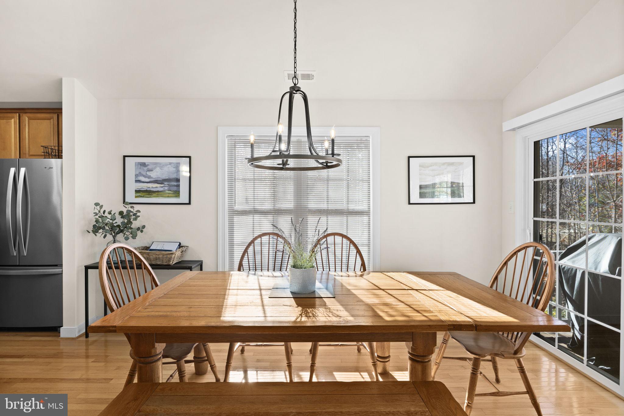 14 Oak Road Bumpass, VA 23024 - Photo 27 of 75 a view of a dining room with furniture a chandelier and wooden floor