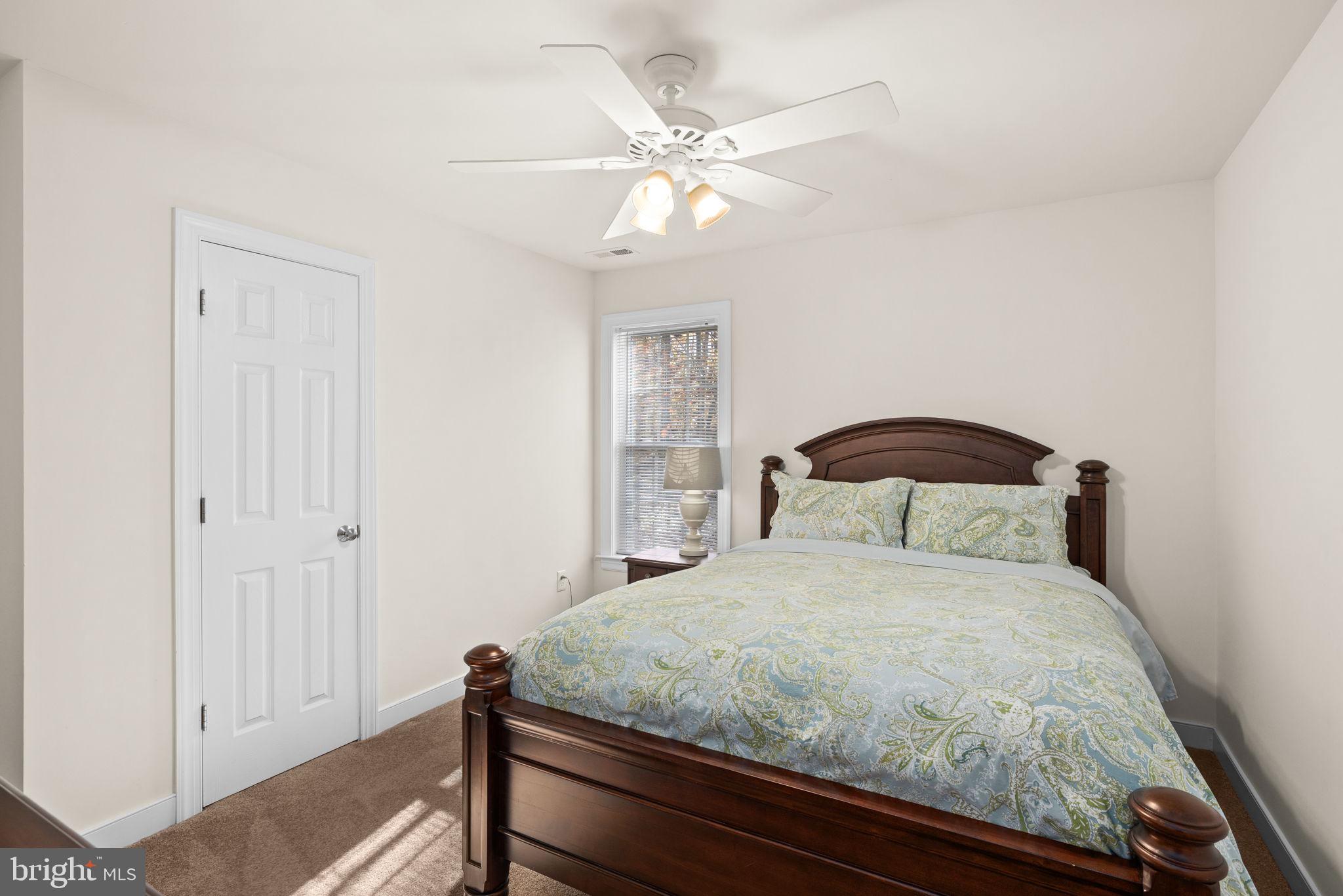 14 Oak Road Bumpass, VA 23024 - Photo 40 of 75 a bedroom with a bed and a chandelier