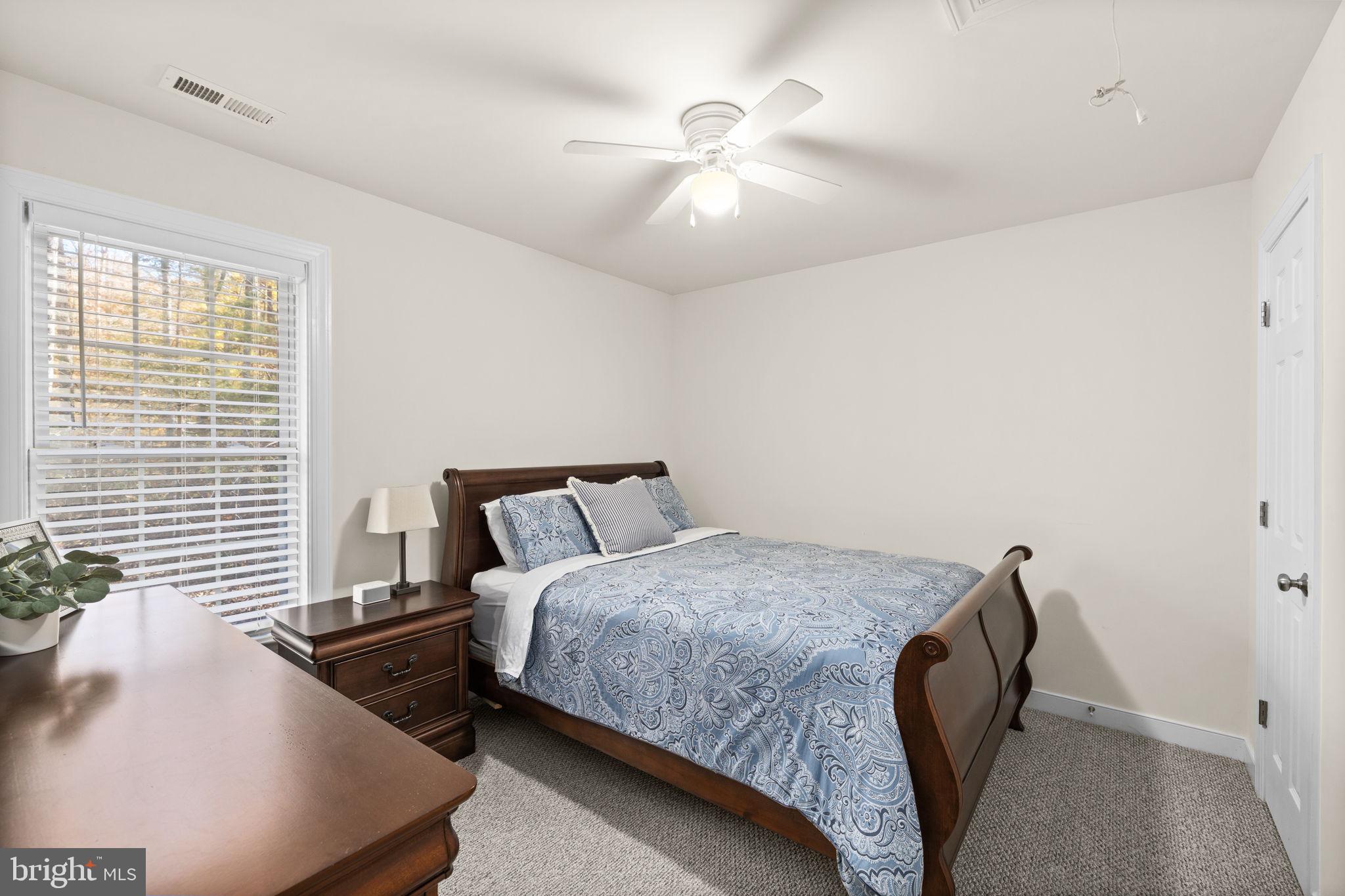 14 Oak Road Bumpass, VA 23024 - Photo 42 of 75 a bedroom with a bed and a chandelier