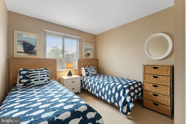 a bedroom with two beds and a window