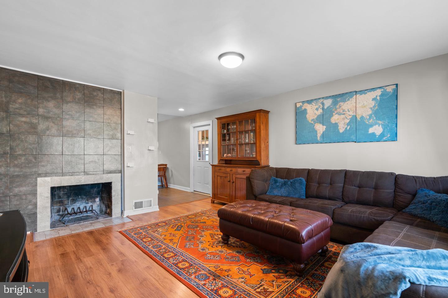 12908 Estelle Road Silver Spring, MD 20906 - Photo 4 of 19 a living room with furniture and a fireplace
