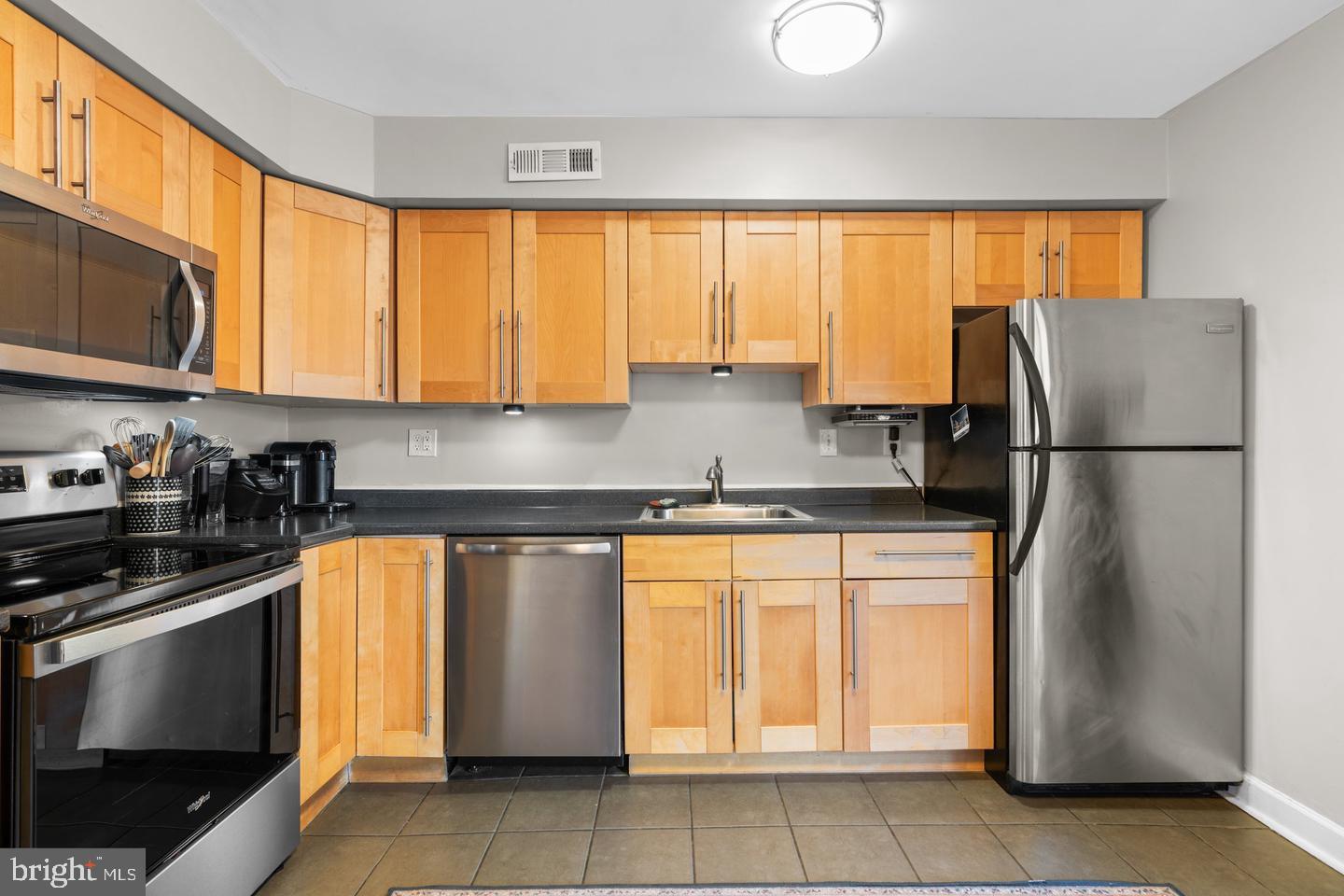 12908 Estelle Road Silver Spring, MD 20906 - Photo 6 of 19 a kitchen with stainless steel appliances granite countertop a refrigerator sink and cabinets