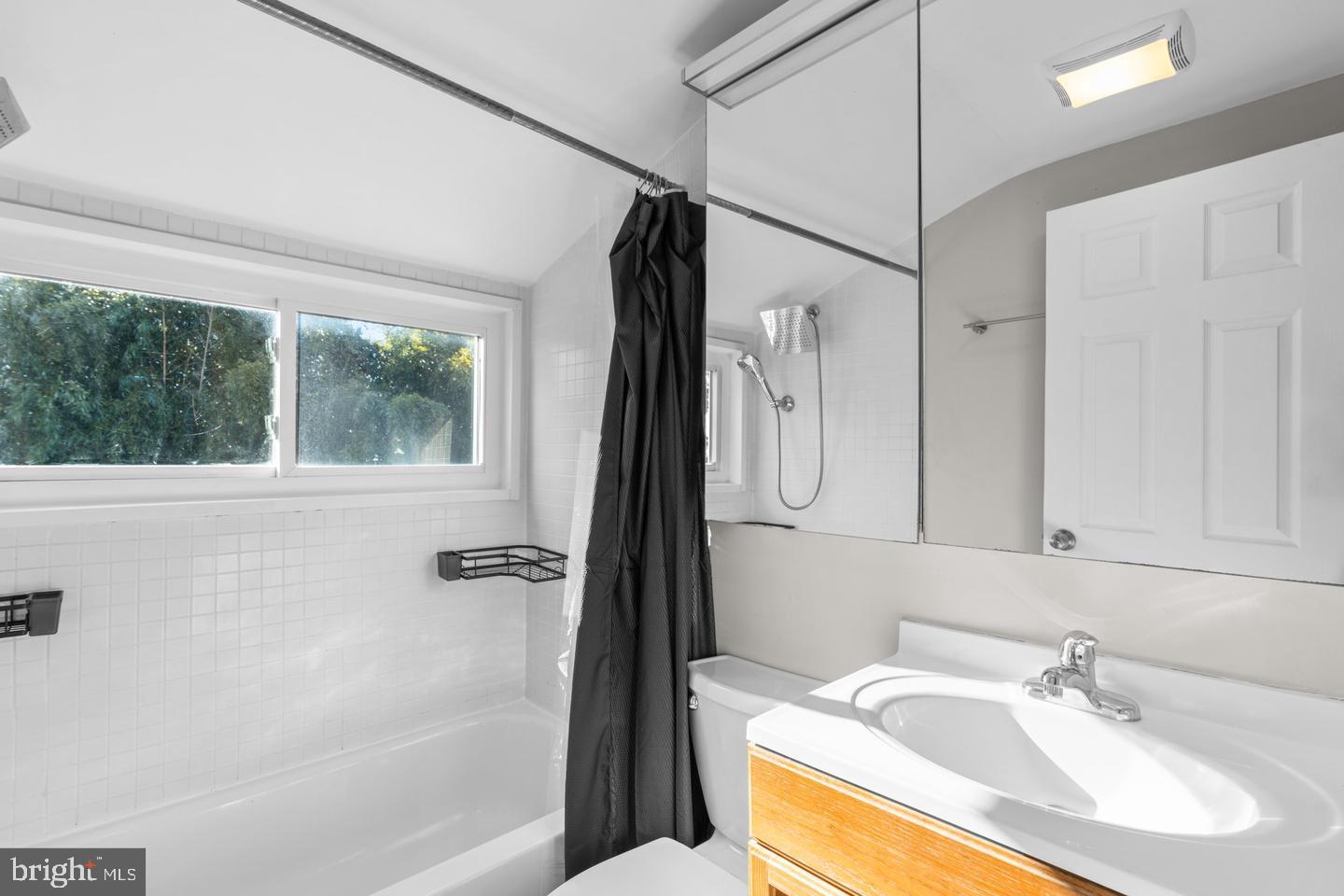 12908 Estelle Road Silver Spring, MD 20906 - Photo 10 of 19 a bathroom with a sink a mirror and a bathtub