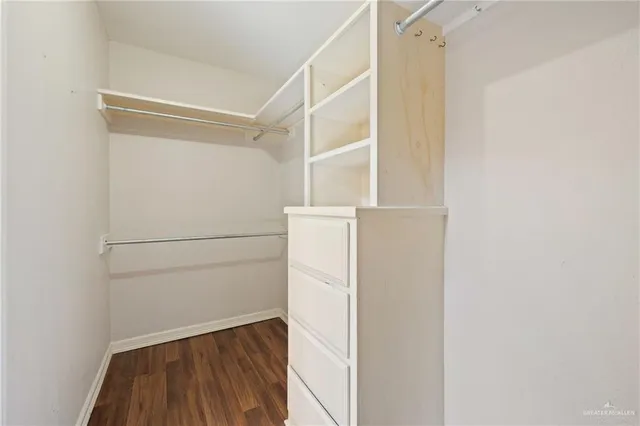 a view of walk in closet with empty racks