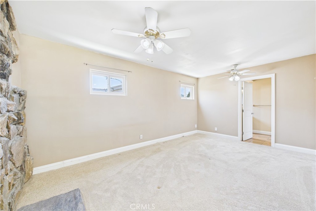 10002 St Elizabeth Circle Cypress, CA 90630 - Photo 13 of 35 an empty room with a ceiling fan and a window