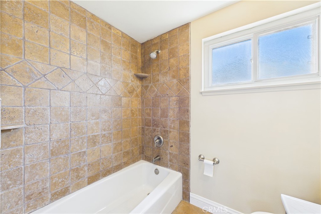 10002 St Elizabeth Circle Cypress, CA 90630 - Photo 17 of 35 a bathroom with a bathtub and shower