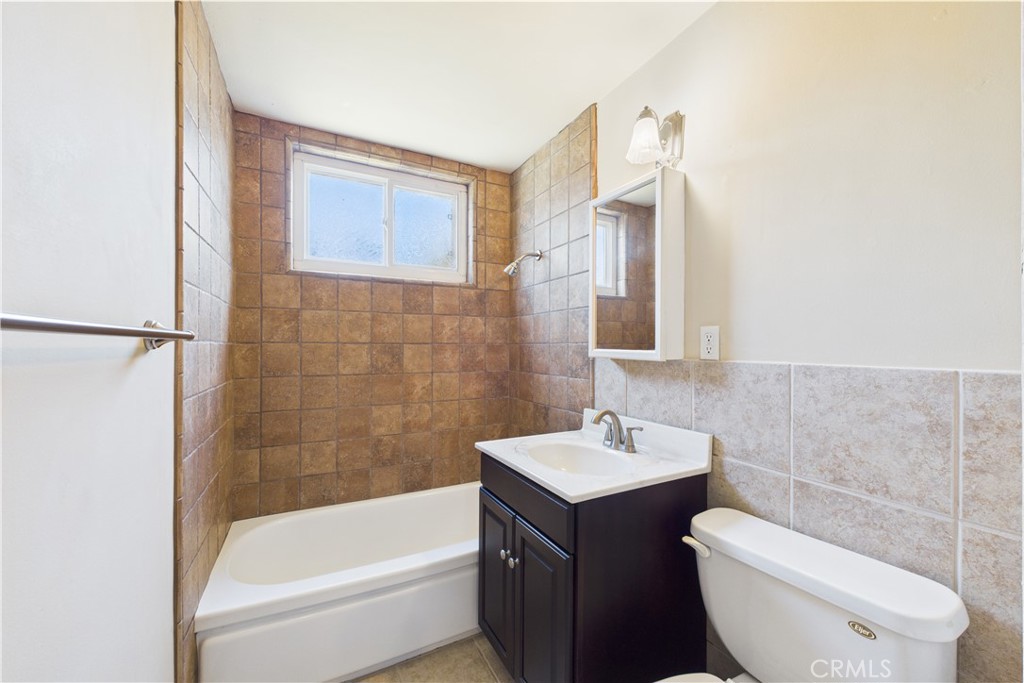 10002 St Elizabeth Circle Cypress, CA 90630 - Photo 20 of 35 a bathroom with a sink a toilet and bathtub