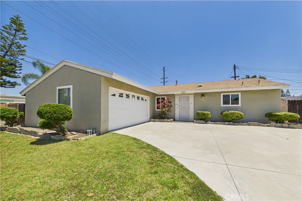 10002 St Elizabeth Circle Cypress, CA 90630 - Photo 2 of 35 a front view of a house with a yard