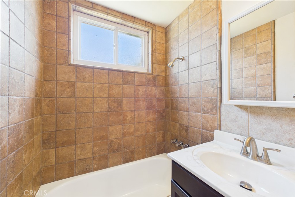 10002 St Elizabeth Circle Cypress, CA 90630 - Photo 21 of 35 a bathroom with a sink shower and a mirror
