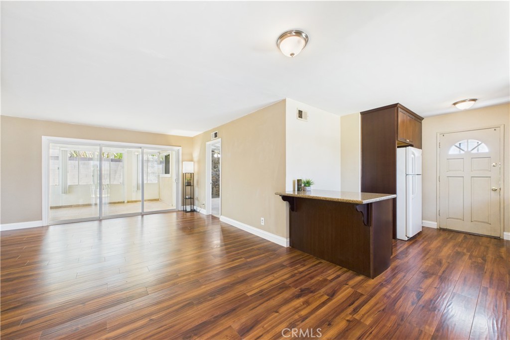 10002 St Elizabeth Circle Cypress, CA 90630 - Photo 5 of 35 a view of an empty room with window and wooden floor