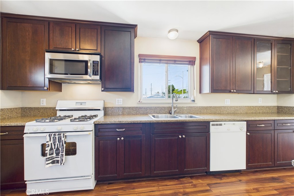10002 St Elizabeth Circle Cypress, CA 90630 - Photo 7 of 35 a kitchen with a sink stove and microwave
