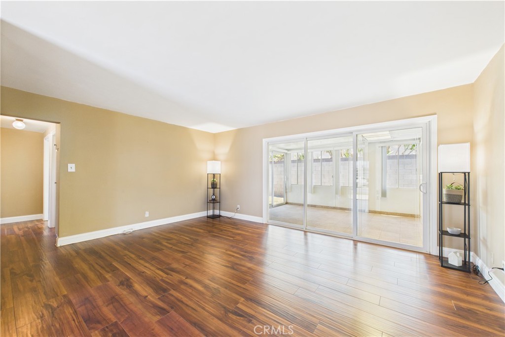 10002 St Elizabeth Circle Cypress, CA 90630 - Photo 8 of 35 a view of an empty room with wooden floor and a window