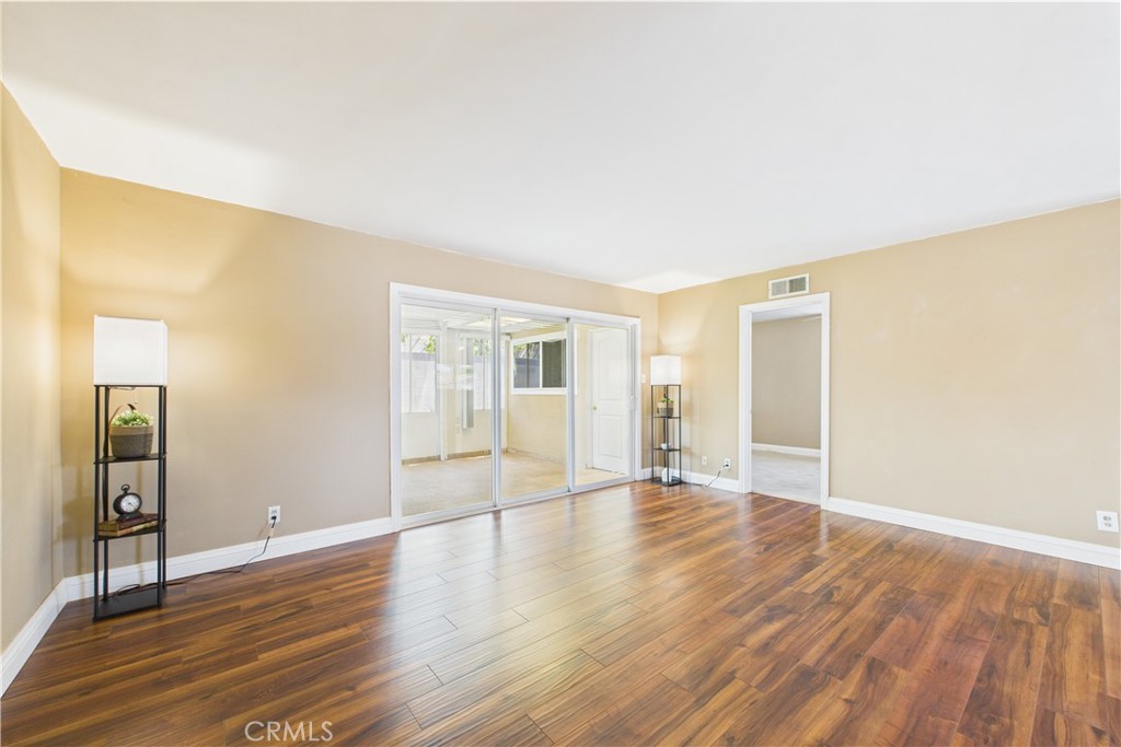 10002 St Elizabeth Circle Cypress, CA 90630 - Photo 9 of 35 a view of an empty room with wooden floor and a window