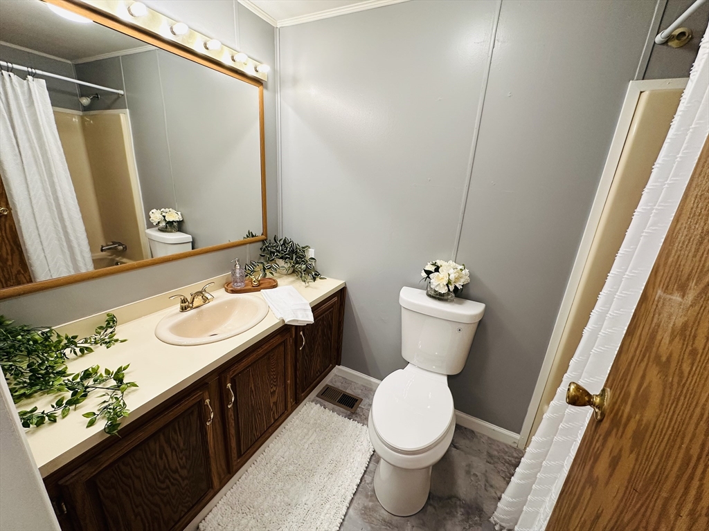 93 Grochmal Avenue, Unit 119 Springfield, MA 01151 - Photo 19 of 33 a bathroom with a double vanity sink and a mirror