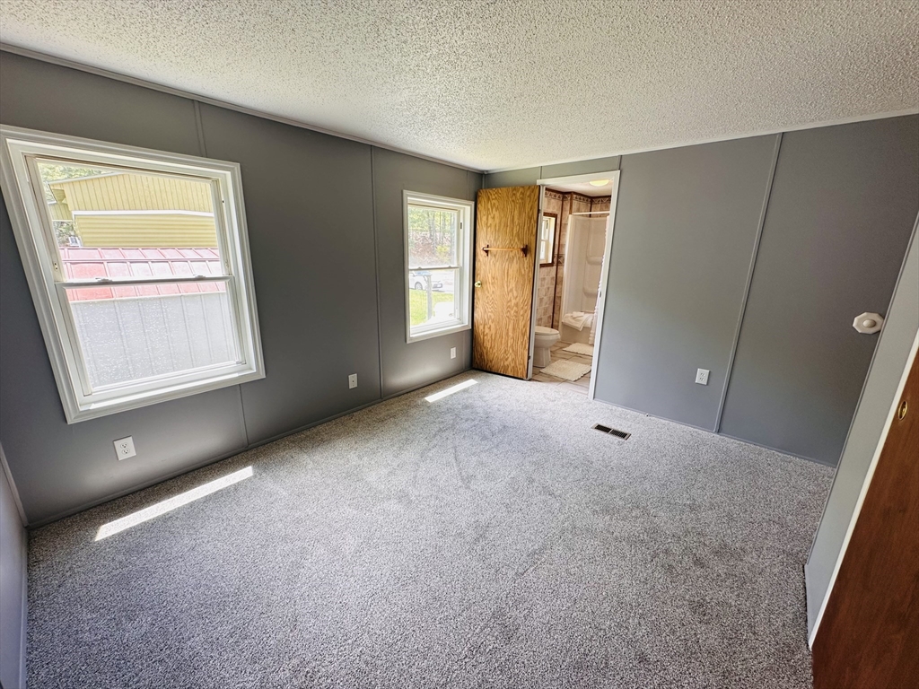 93 Grochmal Avenue, Unit 119 Springfield, MA 01151 - Photo 23 of 33 an empty room with windows and closet