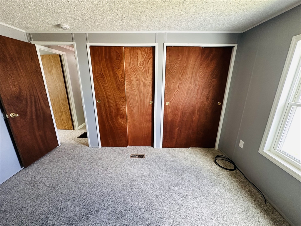 93 Grochmal Avenue, Unit 119 Springfield, MA 01151 - Photo 26 of 33 an empty room with windows and closet