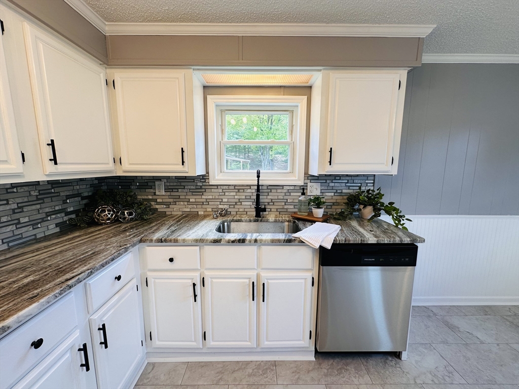 93 Grochmal Avenue, Unit 119 Springfield, MA 01151 - Photo 8 of 33 a kitchen with white cabinets and sink