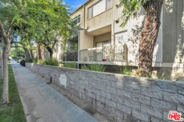 a view of a street with a building in the background