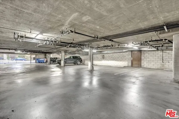 a view of a garage with wooden shelves