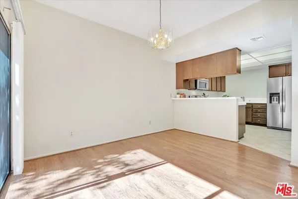 a view of a kitchen with a sink and a refrigerator