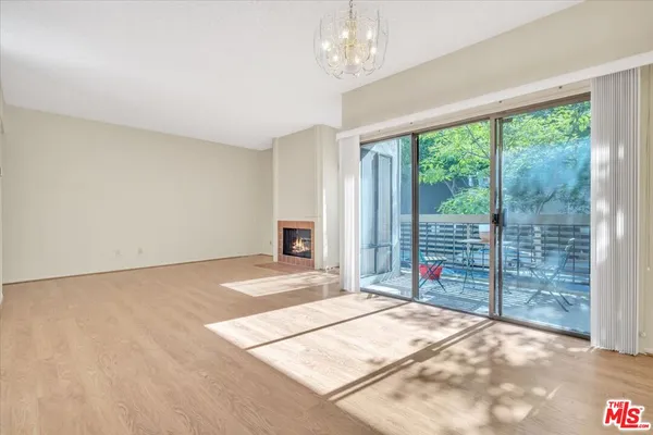 a view of a spacious bedroom with a balcony