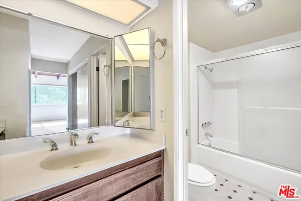 a bathroom with a sink toilet tub and shower