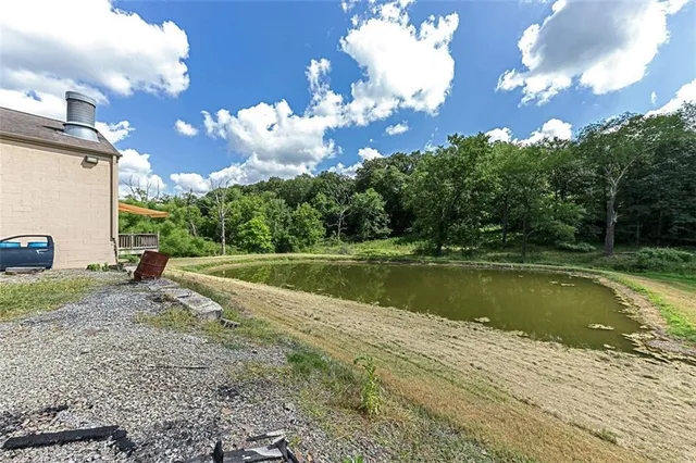 a view of a swimming pool with a yard