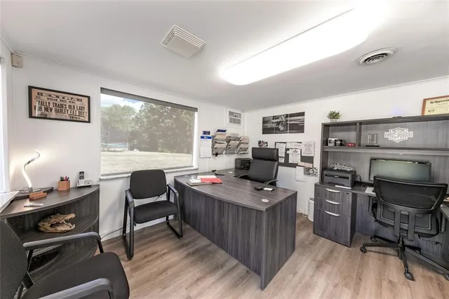 a workspace with furniture and a wooden floor