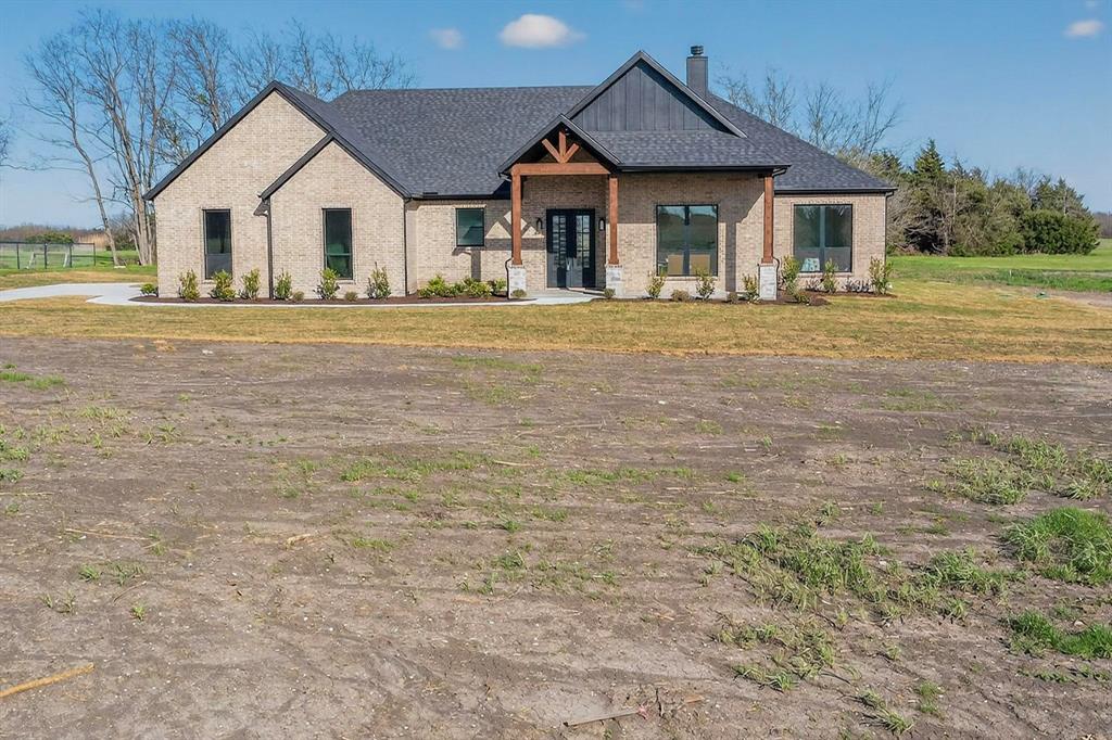 4961 County Road 1098 Celeste, TX 75423 - Photo 3 of 40 View of front facade with a porch, a chimney, brick siding, and a front yard