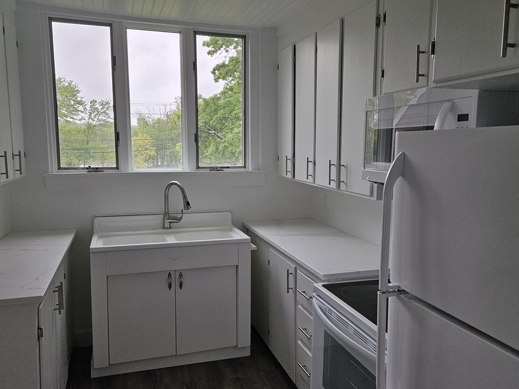 960 Boston Post Road East Marlborough, MA 01752 - Photo 4 of 12 a kitchen with a sink cabinets and window