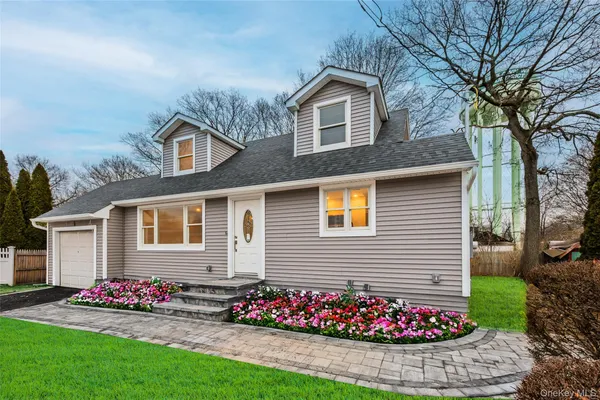 a front view of a house with a garden