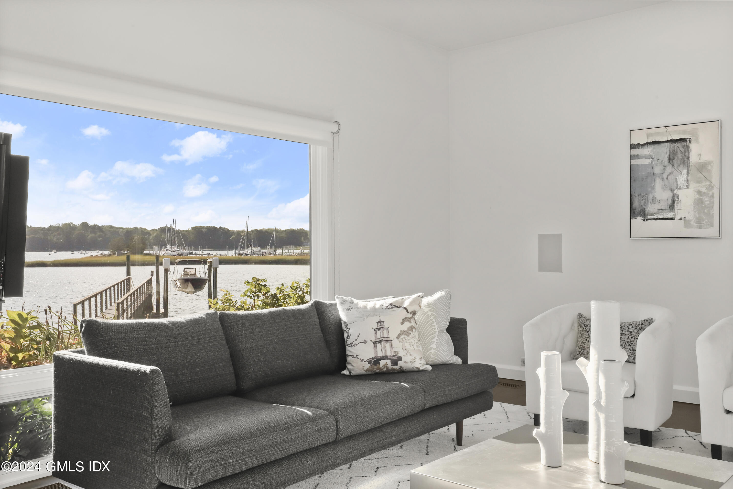 46 Carriglea Drive Riverside, CT 06878 - Photo 12 of 48 a living room with furniture floor to ceiling window and a floor to ceiling window