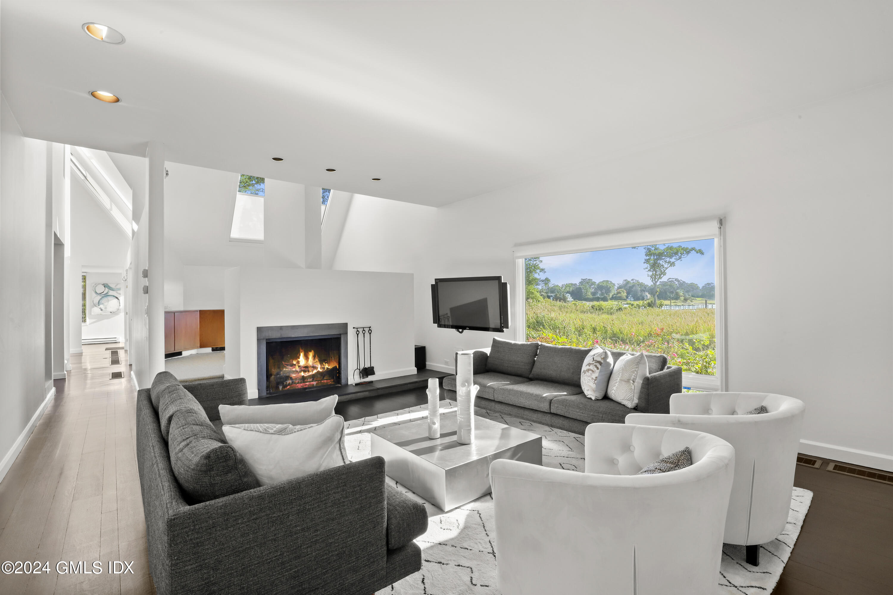 46 Carriglea Drive Riverside, CT 06878 - Photo 10 of 48 a living room with furniture fireplace and a flat screen tv