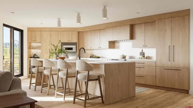 a kitchen with cabinets and chairs