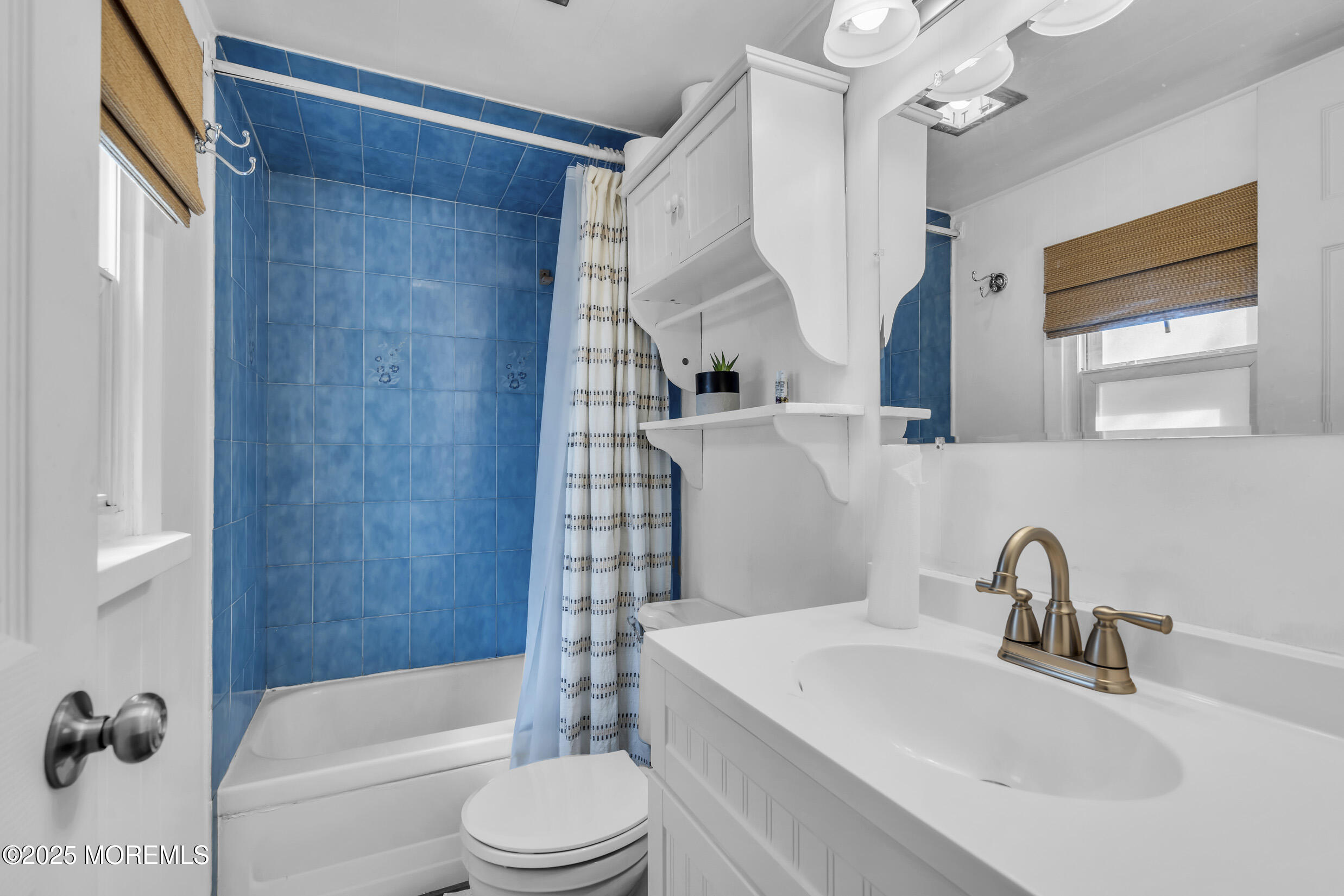 419 Beach Boulevard Forked River, NJ 08731 - Photo 14 of 21 a bathroom with a sink a toilet a mirror a bathtub and shower