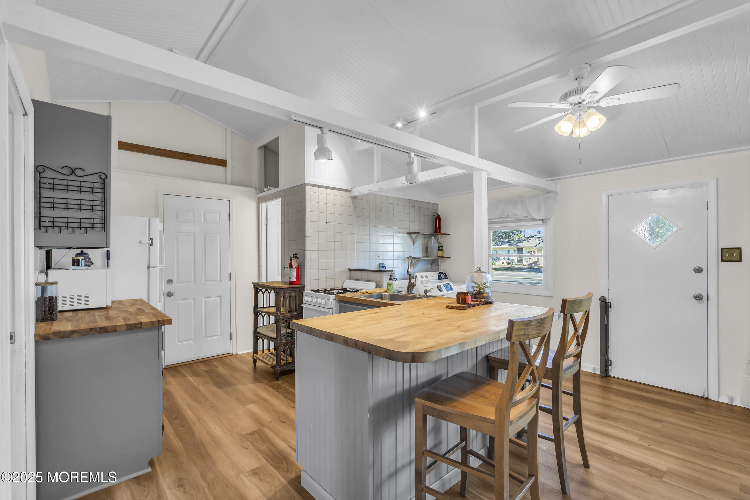 419 Beach Boulevard Forked River, NJ 08731 - Photo 7 of 21 a dining hall with stainless steel appliances granite countertop a dining table and chairs with wooden floor