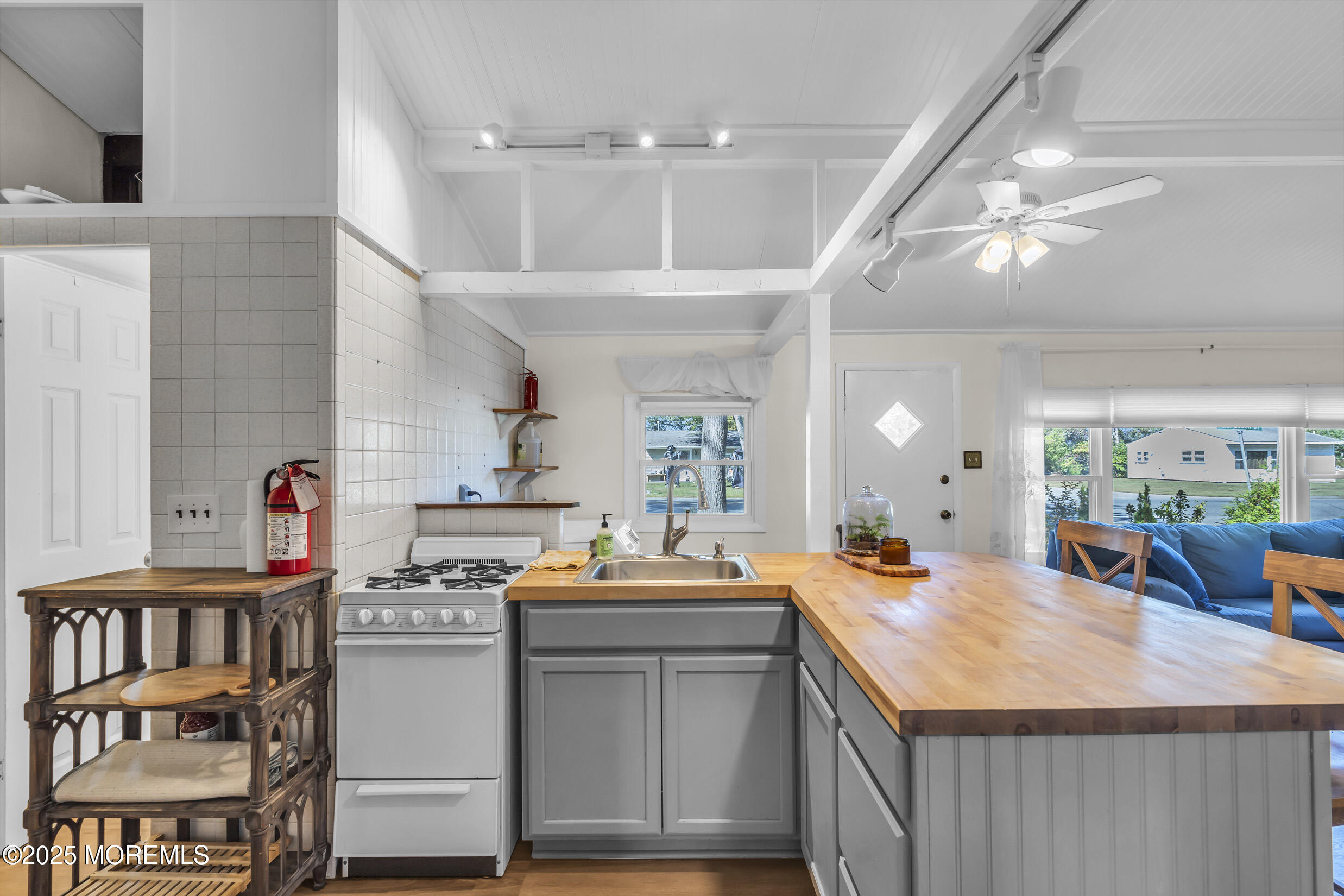 419 Beach Boulevard Forked River, NJ 08731 - Photo 8 of 21 a kitchen with kitchen island a sink appliances and cabinets