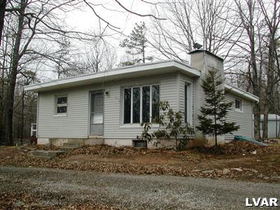 a house that has a tree in front of the house