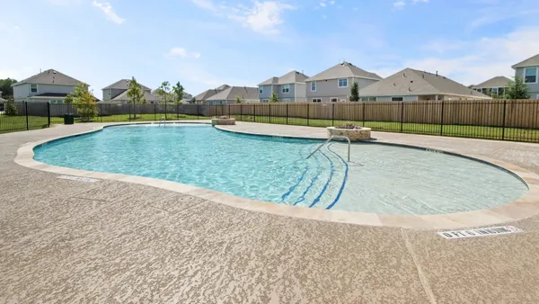 a living room with furniture a rug and a floor to ceiling window